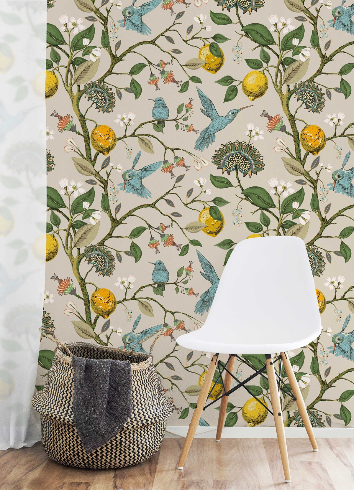 Lemon Grove Hummingbirds wallpaper on a feature wall with a white chair and woven basket