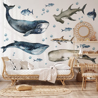 Living room with whale and shark wall decals on a light-colored wall.