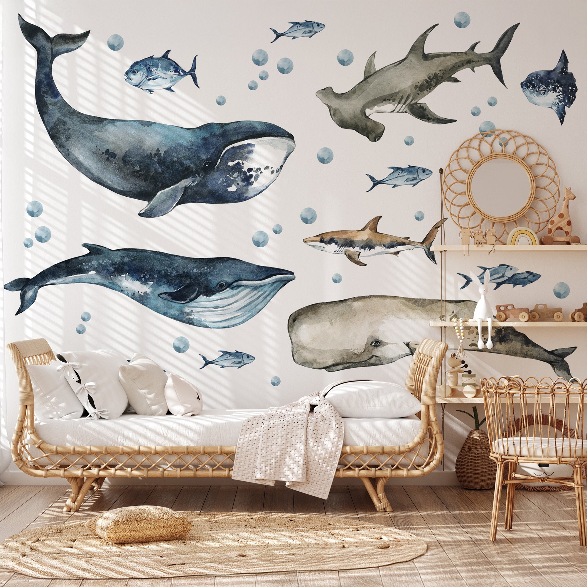 Living room with whale and shark wall decals on a light-colored wall.