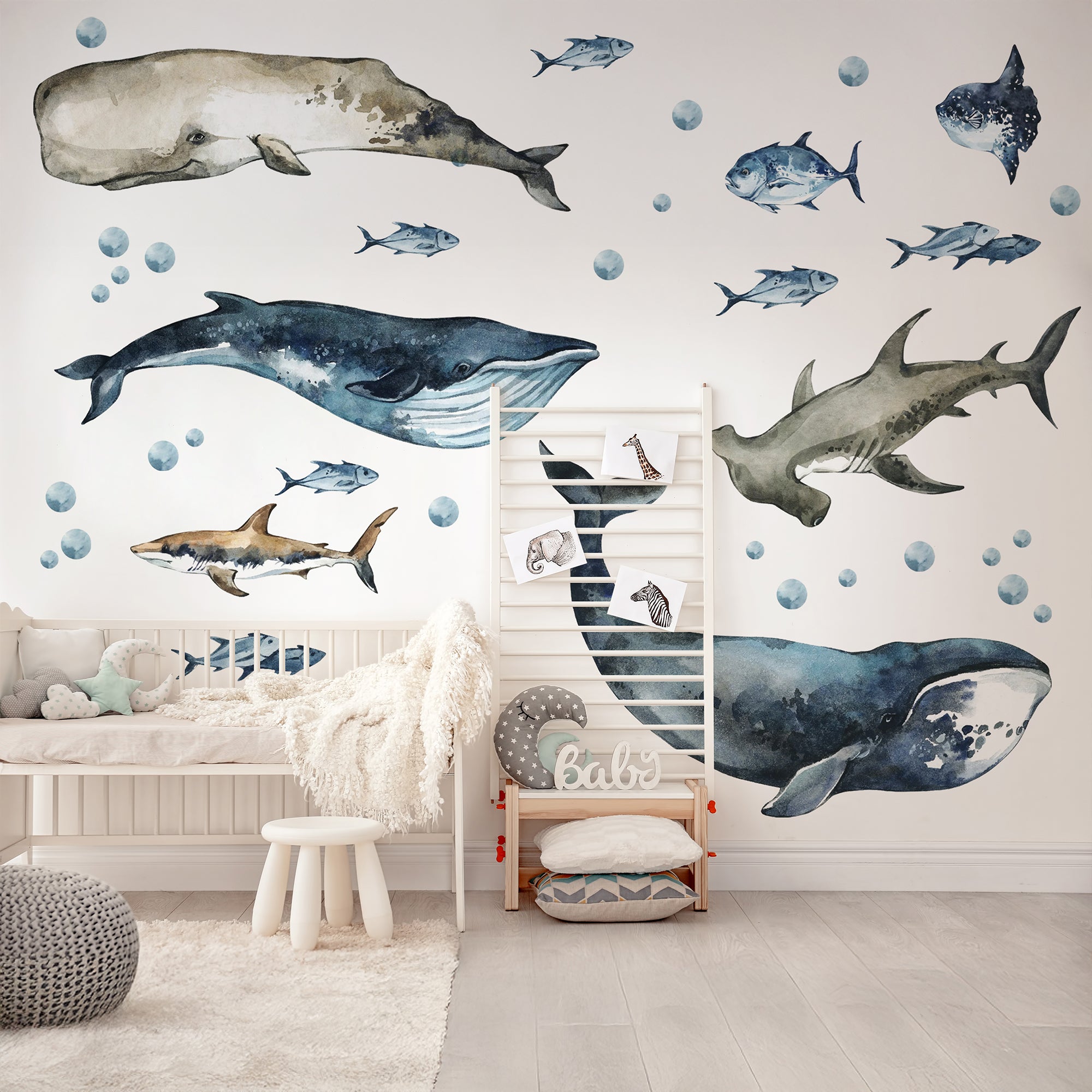 Children's room with whale and shark wall decals on a light-colored floor.