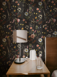 Moody Dark Wildflower Wallpaper beside a table lamp