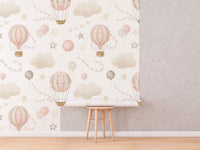Pink Hot Air Balloon Wallpaper roll shown against a wall