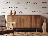Ocean Wave Wall Decals in charcoal above a sideboard