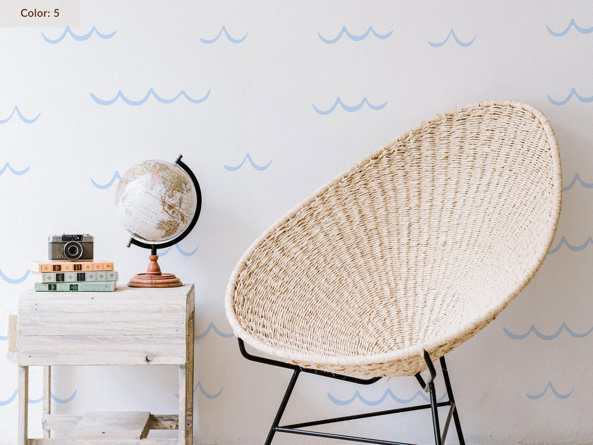 Ocean Wave Wall Decals in pale blue behind a chair