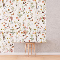 Watercolour Wildflower Wallpaper roll shown against a wall
