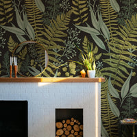 Dark Fern Botanical Wallpaper above a fireplace
