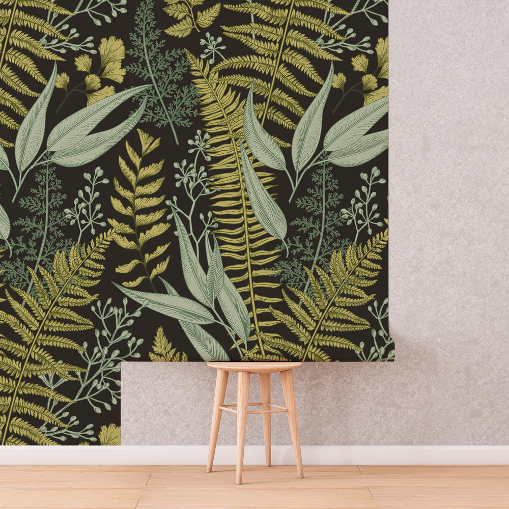 Dark Fern Botanical Wallpaper roll shown against a wall