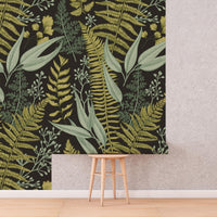 Dark Fern Botanical Wallpaper roll shown against a wall