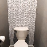 Black and White Herringbone Wallpaper in a cloakroom