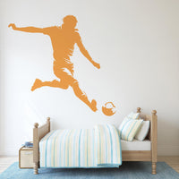 Football Player Wall Decal in orange above a bed