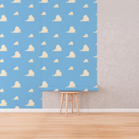 Blue Cloud Wallpaper roll shown against a wall