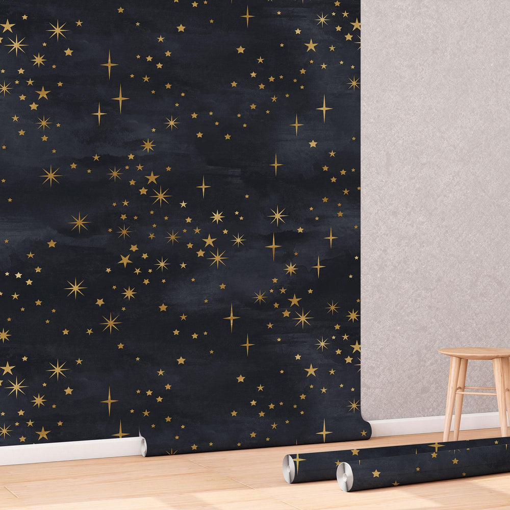 Celestial Starry Night Wallpaper roll shown against a wall
